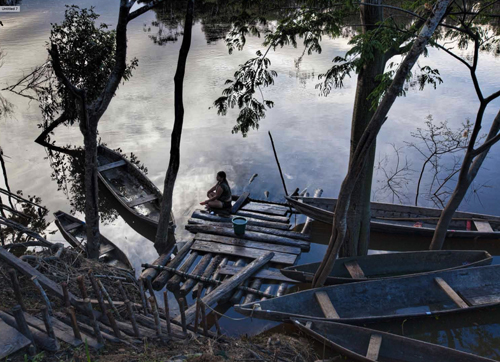 A client waits on one of the docks leading up from the Amazon to the village.
